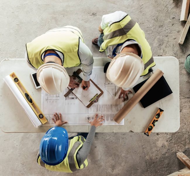architect-engineer-and-teamwork-with-blueprint-from-above-on-a-building-or-contractor-project-bui.jpg